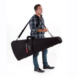 Man carrying a Matthews C-Stand Shoulder KitBag with adjustable straps, showcasing a durable solution for transporting C-Stands in small productions.