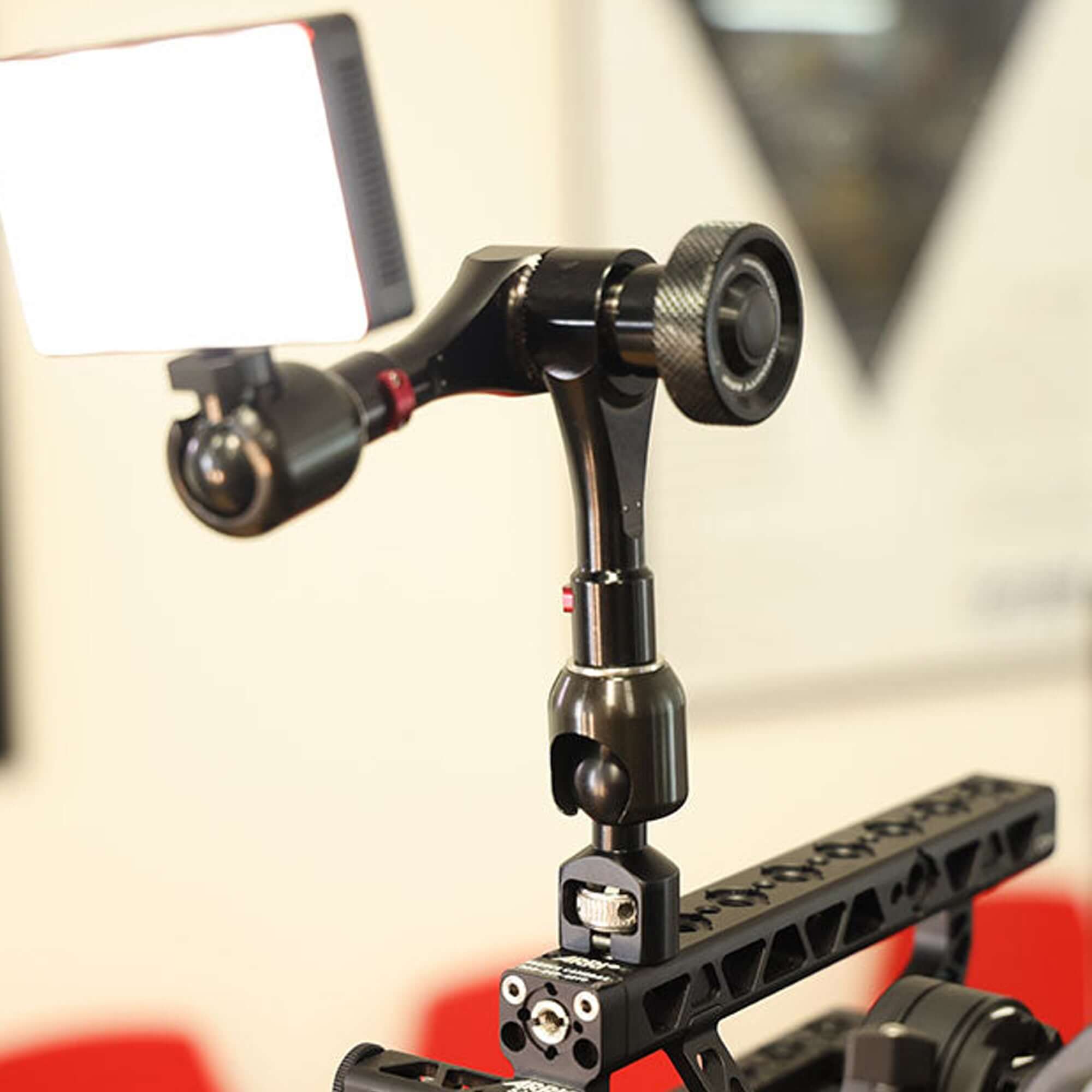 Close-up of a camera light mount showcasing a robust support arm for enhanced lighting in photography.