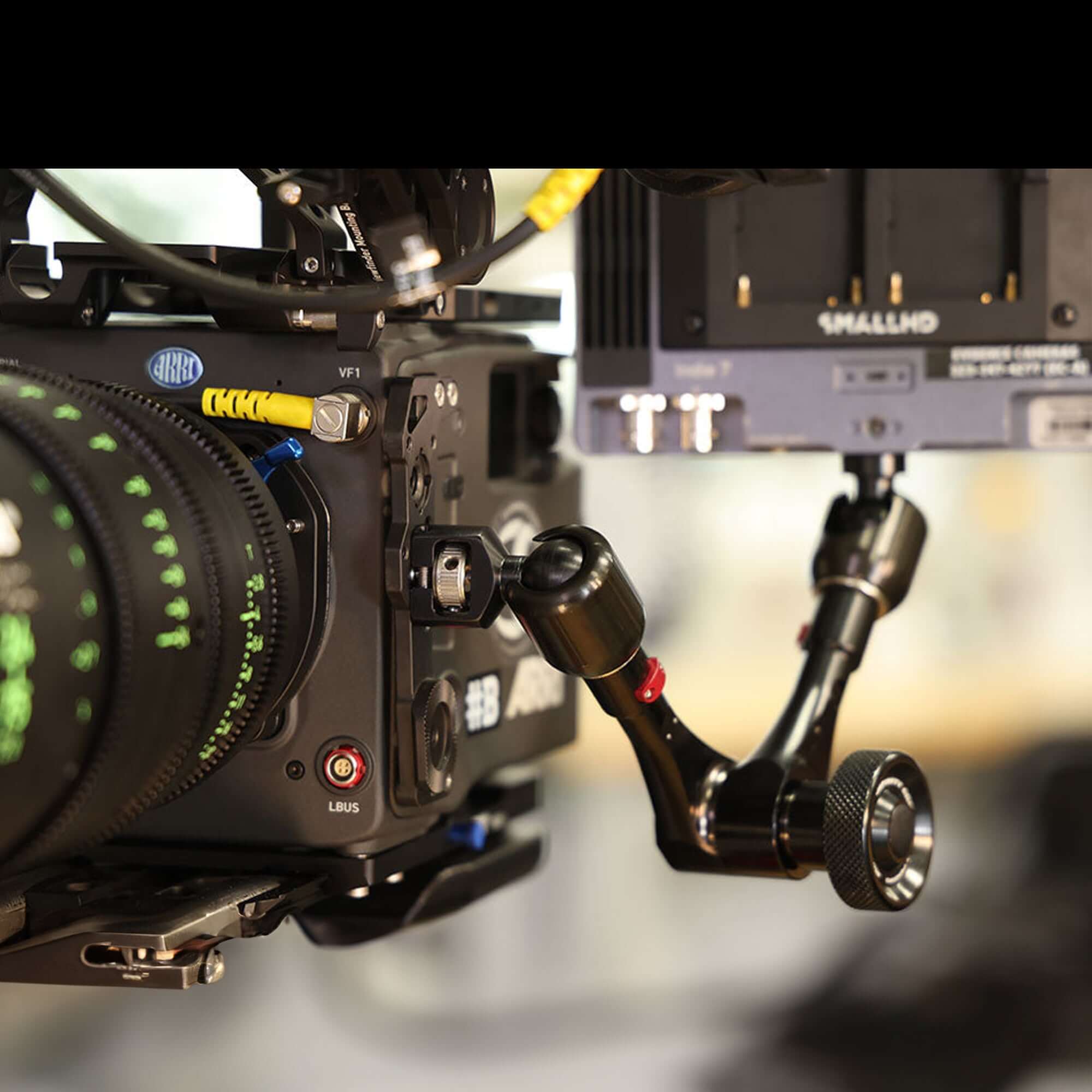 Close-up of a professional cinema camera rig with focus on the lens and mounting accessories, showcasing precision gear.