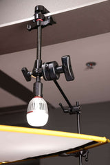 Black Hyper-Chrome™ Matthellini2 Clamp holding a light fixture, showcasing durable design and enhanced functionality.