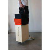 Person carrying Apple Box with Apple Box Topper seat cushion from Matthews, ideal for comfortable seating on set.