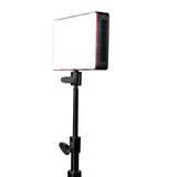 Compact LED light mounted on adjustable stand for professional photography and videography.