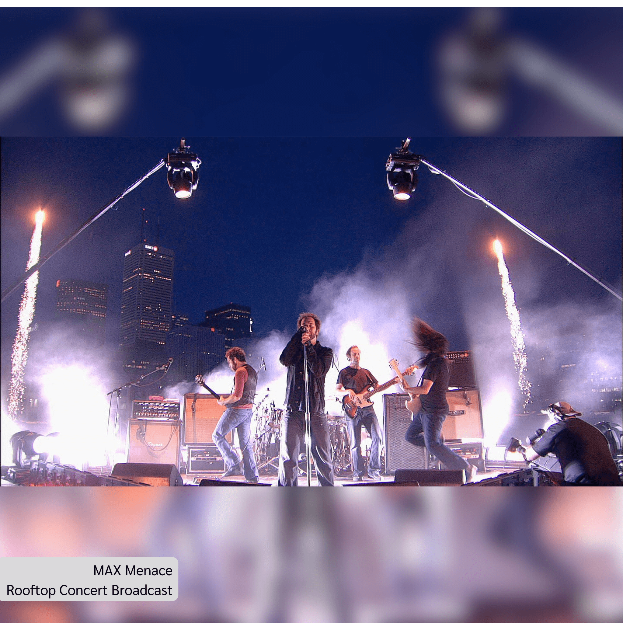 MAX Menace performing live at a rooftop concert with city skyline and fireworks, showcasing a vibrant musical experience.