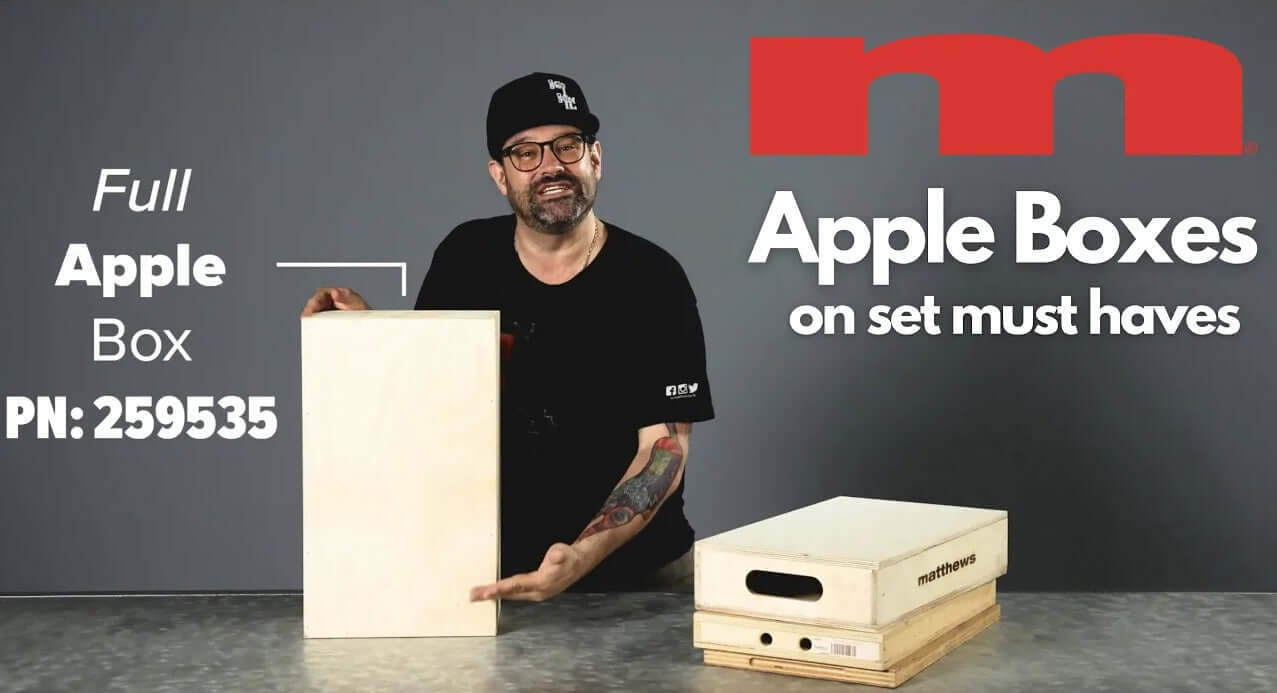 Person displaying Full Apple Box and stacked boxes with PN: 259535 branding, labeled "Apple Boxes on set must haves."