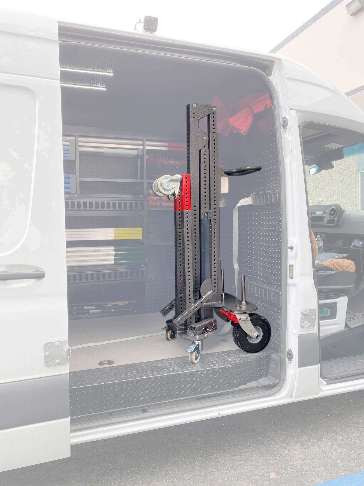 Middle MAX Menace Arm boom stand stored inside a studio van with shelving and equipment.