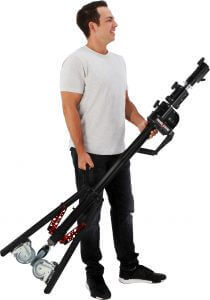 Man carrying a Panel Stand Boom Kit, showcasing portability and ease of use for lighting setups.